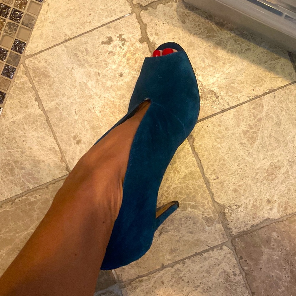 Pair of teal colored high heel open toe booties